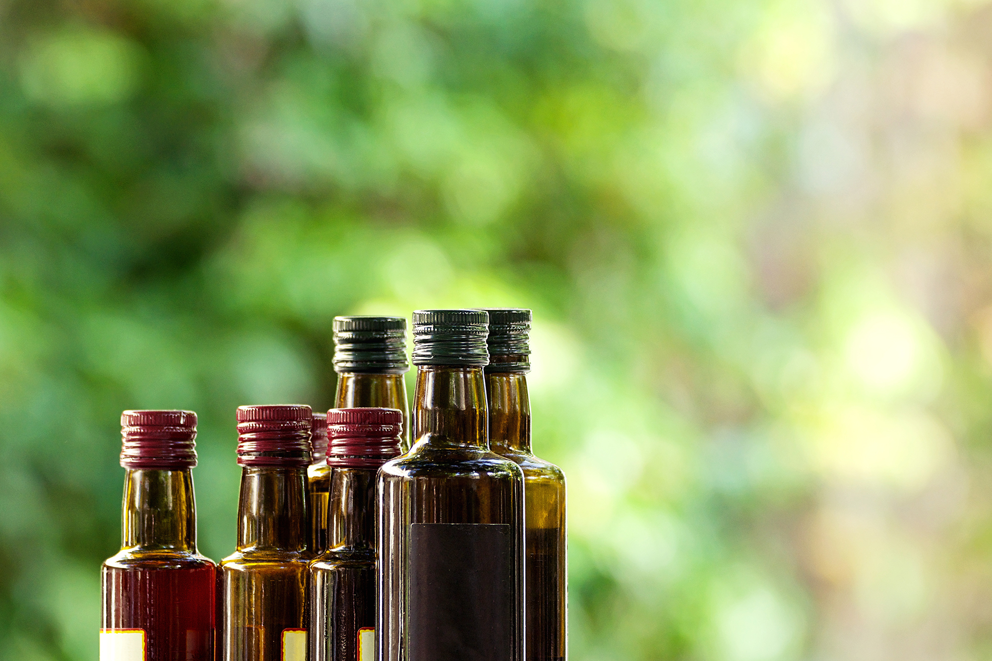 Set of bottles of oil and vinegar on the outdoor terrace of a ba